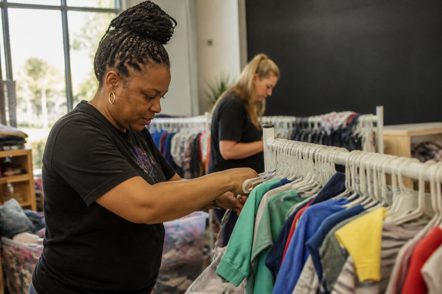 A quick guide for where to donate baby clothes in Omaha: volunteers restock children’s clothing racks before a monthly free Shopping Day at Trey’s Boutique in Downtown Ralston.